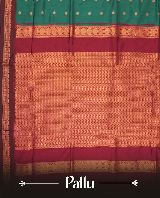 Green colour Kalyani Cotton saree with golden motifs, paired with a contrasting maroon border featuring intricate zari work & Comes with a matching blouse piece.