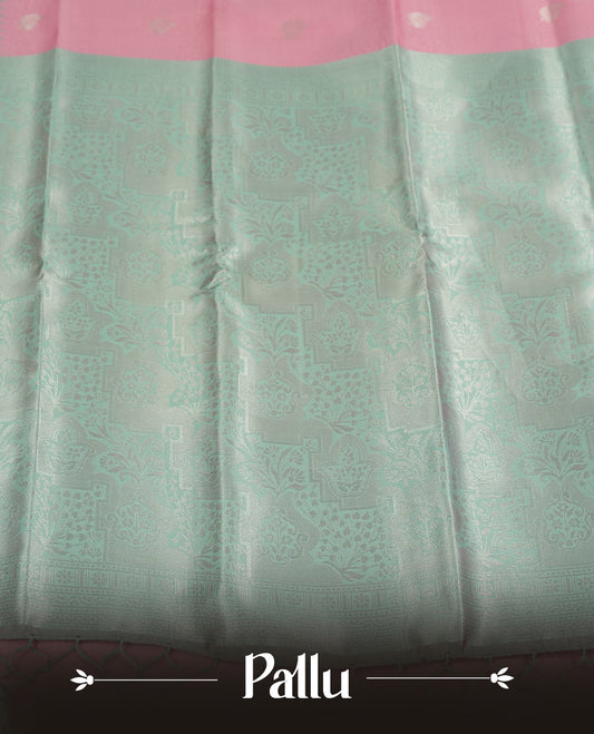 Light pink colour semi silk saree adorned with silver zari designs on the body, complemented by a contrasting light green and silver border and pallu, and paired with a matching blouse piece