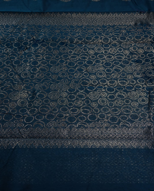 Cobalt blue colour silk cotton saree adorned with a shimmering silver zari border and intricate woven designs, blending elegance with tradition, Paired with a matching blouse, its perfect for festive and special occasions.