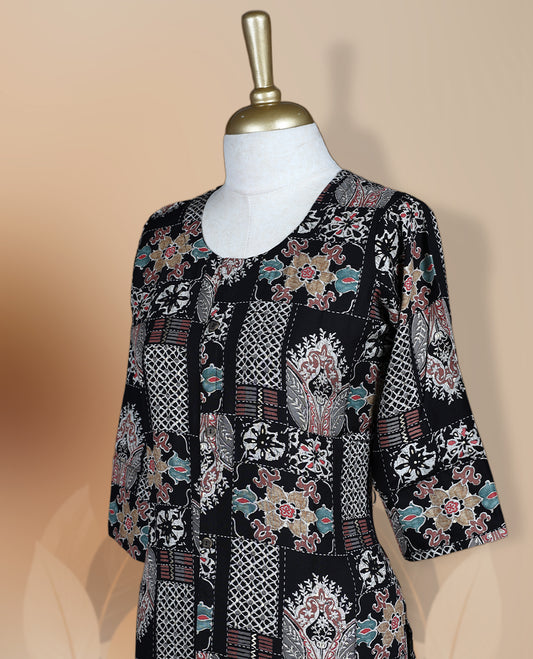 Black colour kurthi adorned with delicate floral prints, featuring a round neckline and three quarter sleeves & Crafted for comfort and style, perfect for casual and semi formal occasions.