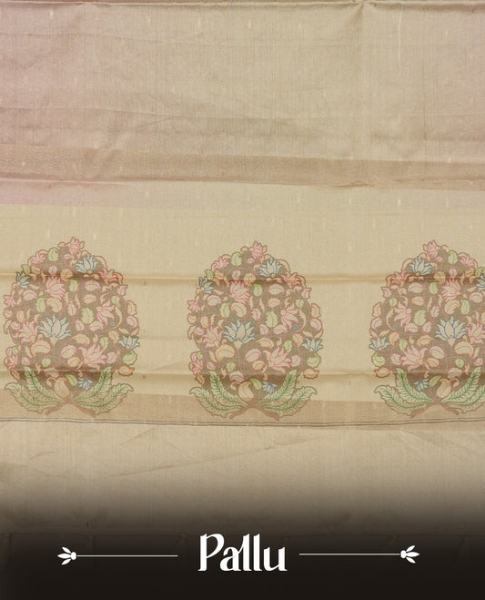 Rose gold colour semi tussar saree adorned with gold zari motifs across the body and Floral pattern contrast cream colour on border, paired with a matching blouse.