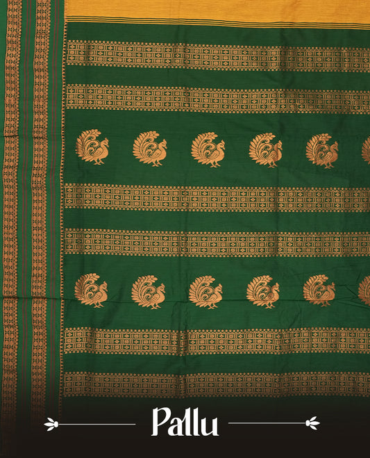 Mustard yellow Kalayani cotton saree with delicate woven motifs on the body, enhanced by a rich green zari border and pallu with traditional patterns, paired with a matching blouse piece.