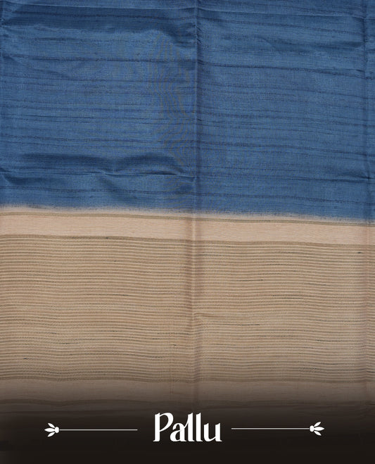 Blue colour semi tusser silk saree featuring contrast cream colour London bridge printed pattern border and paired with matching blouse.