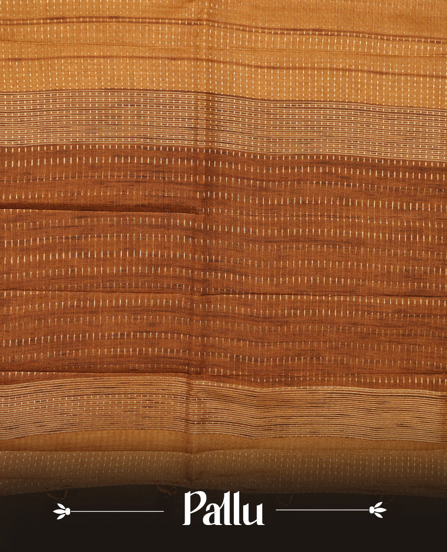 Antique gold colour semi tussar silk  saree highlighting gold zari dotted stripes, self colour border and contrast dark gold pallu and comes with matching blouse piece.