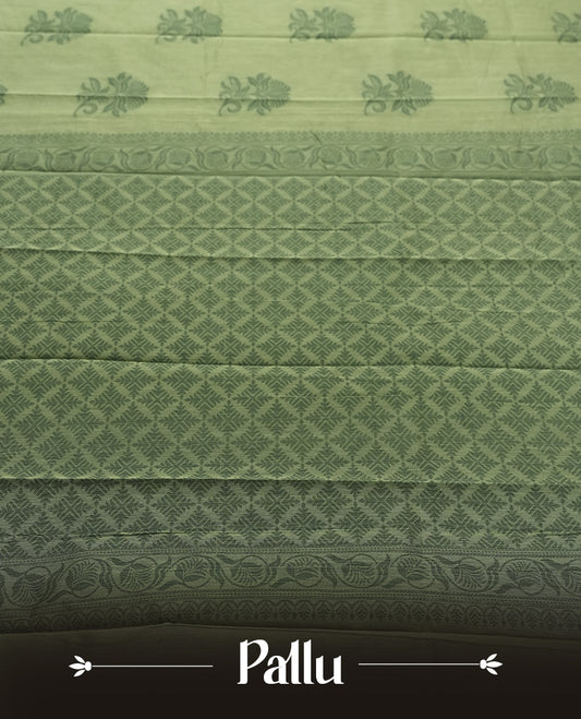 Pastel green colour silk cotton saree featuring elegant floral zari motifs on the body, complemented by a rich contrast dark green border and pallu with traditional woven detailing & Comes with a matching blouse piece.