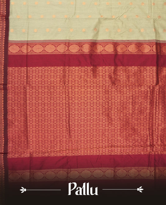 Grey colour Kalyani Cotton saree in deep maroon with golden motifs, paired with a contrasting maroon border featuring intricate zari work & Comes with a matching blouse piece.