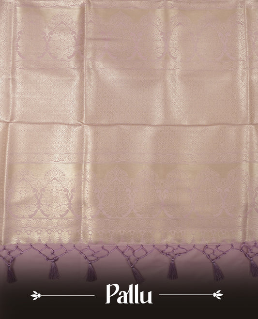 Lavender colour semi soft silk saree featuring an all-over woven leaf pattern in gold colour , finished with a matching border adorned with detailed paisley and floral motifs, and a matching blouse piece.