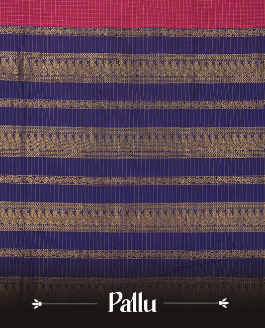 Burnt maroon coloured mixed Kalyani cotton saree featuring golden zari checks on the body, complemented by a dark royal blue coloured border and pallu adorned with golden zari patterns, Paired with a matching blouse.