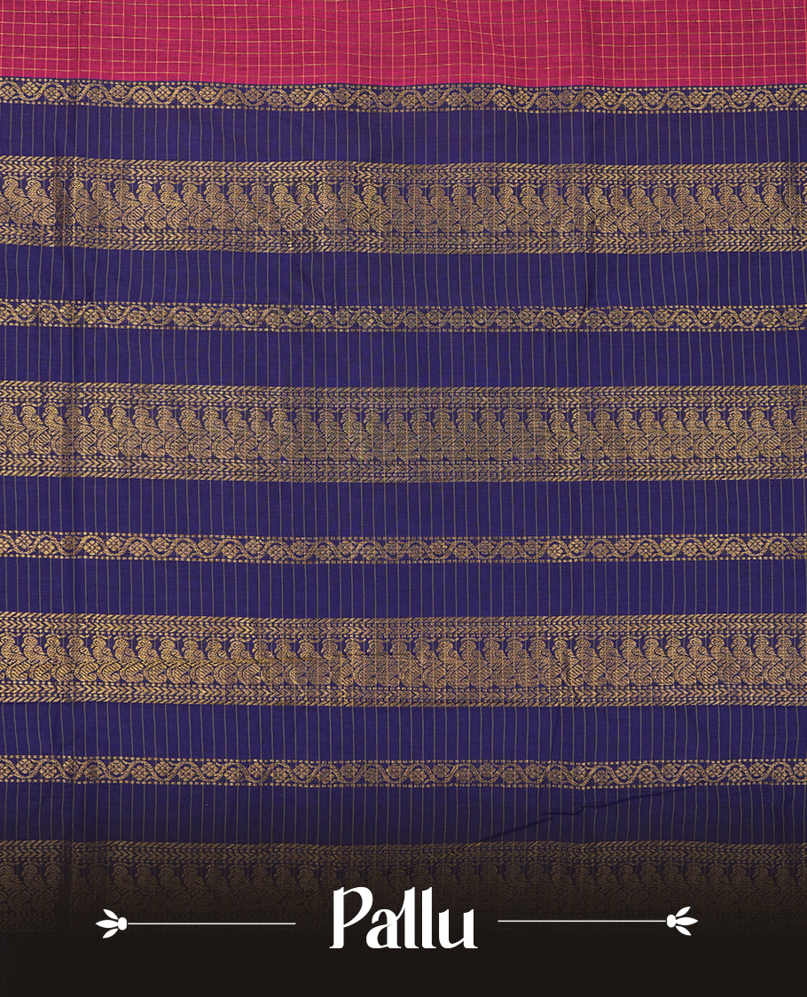 Burnt maroon coloured mixed Kalyani cotton saree featuring golden zari checks on the body, complemented by a dark royal blue coloured border and pallu adorned with golden zari patterns, Paired with a matching blouse.