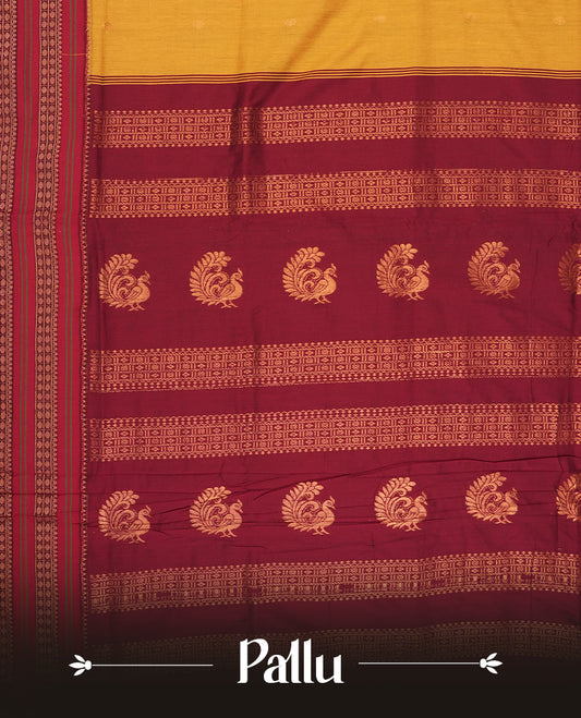 Mustard yellow Kalayani cotton saree with delicate woven motifs on the body, enhanced by a rich maroon contrasted zari border and pallu with traditional patterns, paired with a matching blouse piece.