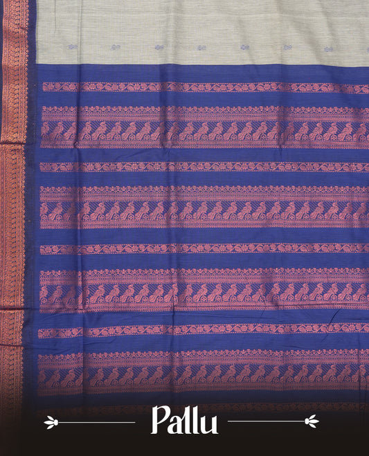 Grey colour Kalyani Cotton saree with delicate woven zari royal blue motifs all over, paired with a contrasting royal blue border and pallu intricately woven with rich copper zari & Comes with a matching blouse piece.