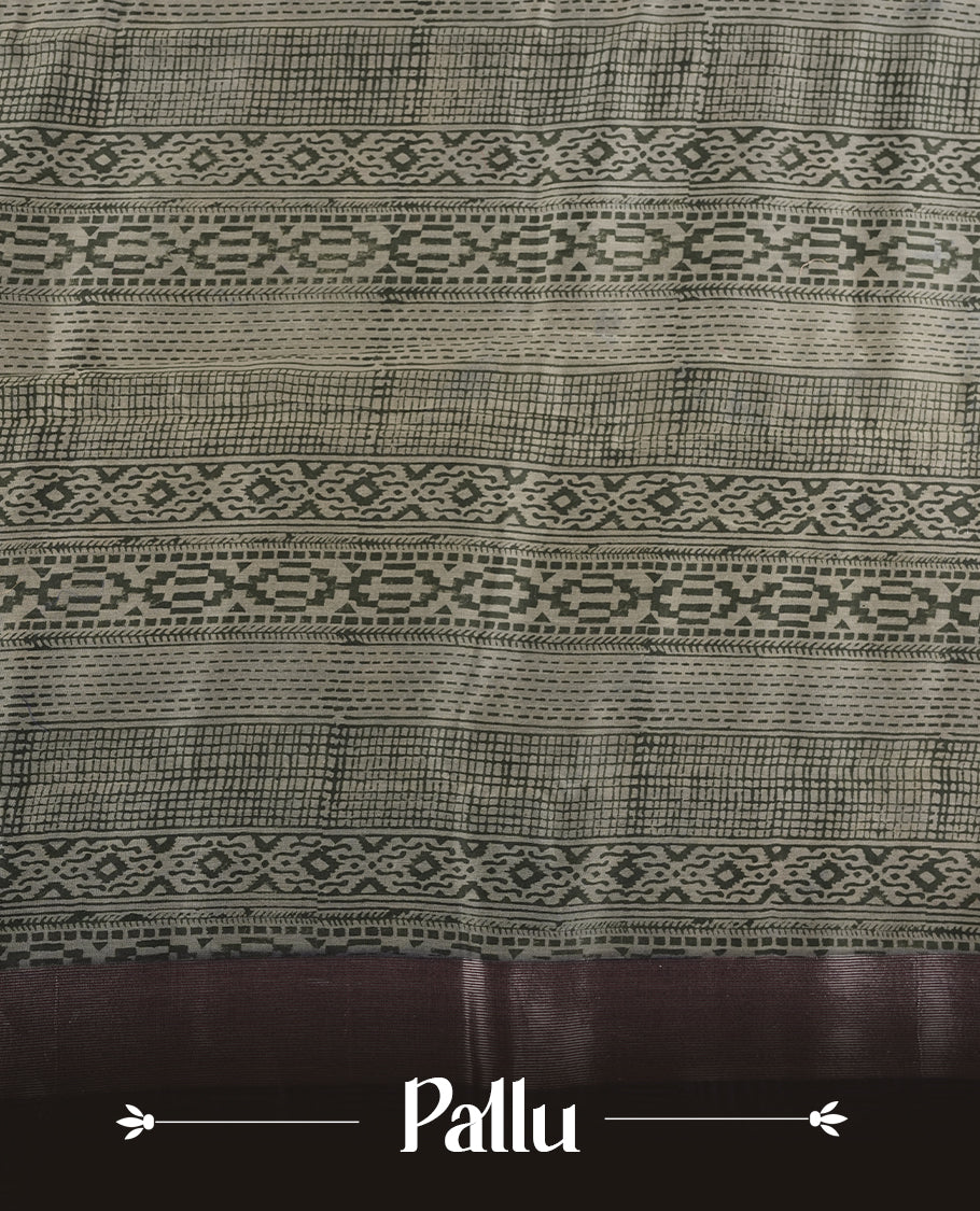 Greenish Gray colour chanderi silk saree featuring geometric print pattern across body, with contrast Blue colour border with zari pattern and paired with matching blouse.