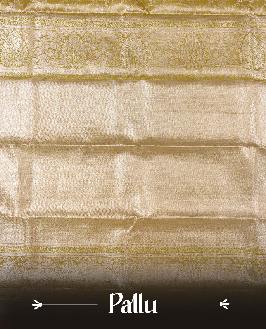 Light olive-gold antique zari tissue brocade saree with delicate woven floral motifs, a traditional gold zari border and pallu, paired with a matching blouse.