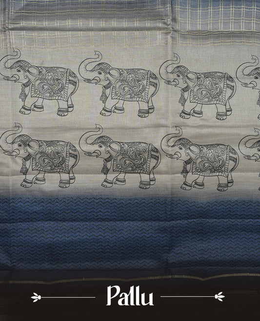 Ash blue colour semi tusser silk saree featuring Gold zari check pattern across body, faded contrast cream colour border with elephant print and paired with matching blouse.