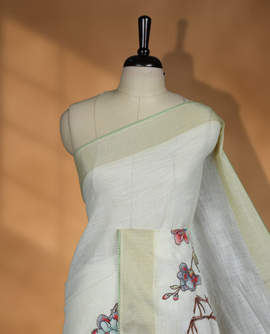 Cream colour cotton linen silk saree featuring Floral  & brids printed pattern on body, golden simple border with green colour pallu and comes with a matching blouse