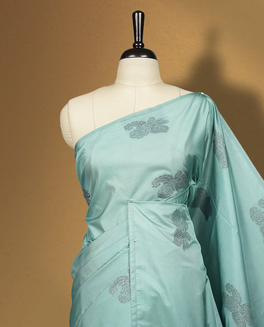 Pastel blue colour semi soft silk saree, adorned with subtle woven floral motifs on the body & The design is elevated with an elegant zari border and pallu, paired with a matching blouse.
