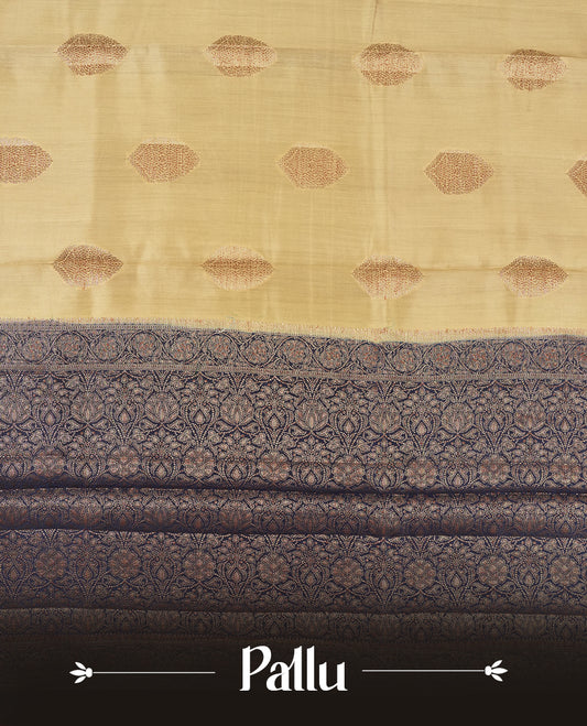Cream Beige Colour Banaras Soft Silk Saree with Gold Zari Oval Mandala Buttas, Intricate Multi-Layered Decorative Pallu Border, Grand Pallu with Ornate Circular and Foliate Motifs in Navy Blue and Gold Tones, and Matching Navy Blue Blouse