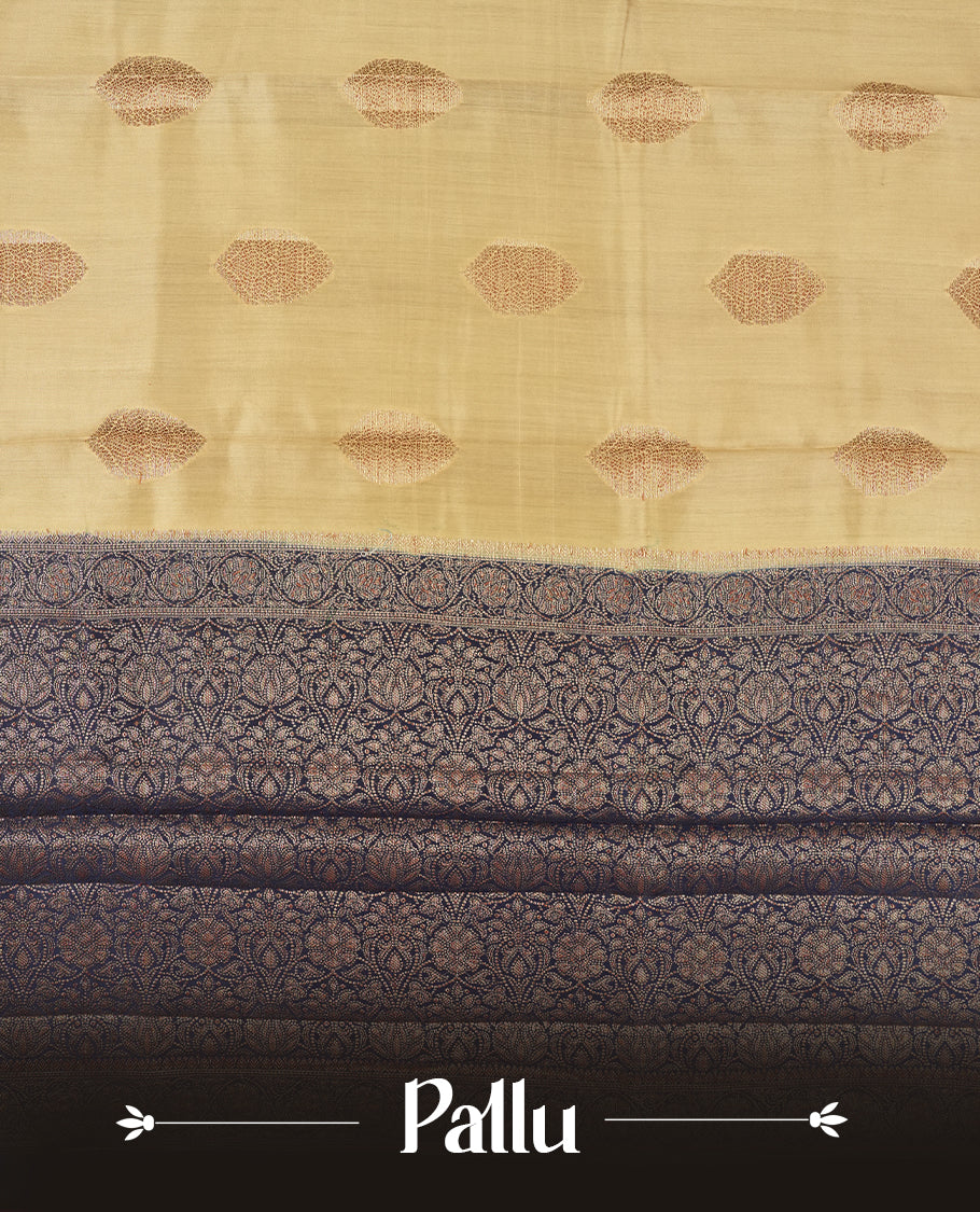 Cream Beige Colour Banaras Soft Silk Saree with Gold Zari Oval Mandala Buttas, Intricate Multi-Layered Decorative Pallu Border, Grand Pallu with Ornate Circular and Foliate Motifs in Navy Blue and Gold Tones, and Matching Navy Blue Blouse