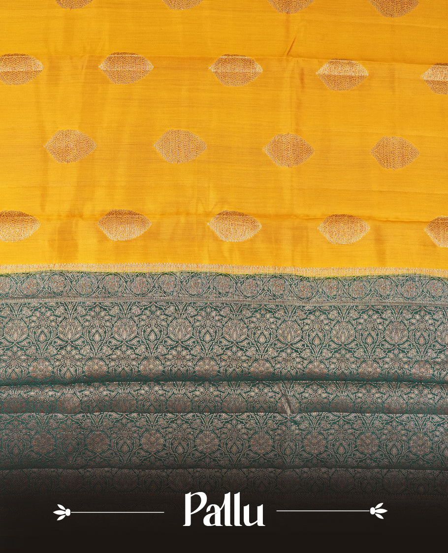 Mustard Yellow Colour Banaras Soft Silk Saree with Gold Zari Oval Buttas, Intricate Multi-Layered Floral Border, Grand Pallu with Ornate Lotus and Vine Motifs in Teal and Gold Tones, and Matching Teal Blouse.