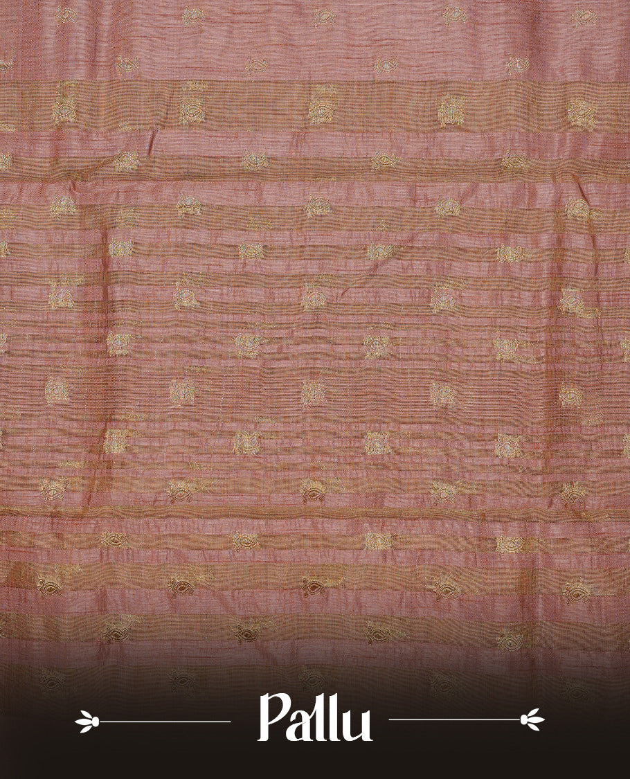 Salmon pink colour semi tussar silk saree featuring small gold zari mango motifs across the body, enhanced with a self colour border showcasing elegant gold zari mango patterns. Paired with a matching blouse piece.