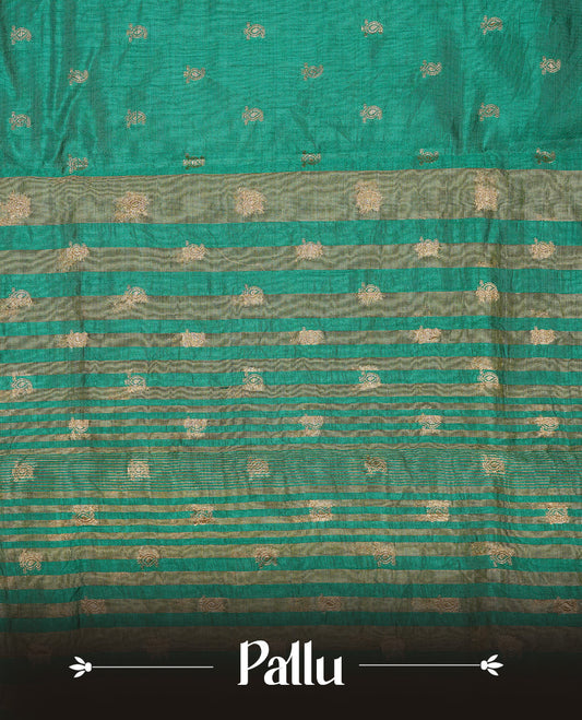 Green colour semi tussar silk saree featuring small gold zari mango motifs across the body, enhanced with a self colour border showcasing elegant gold zari mango patterns. Paired with a matching blouse piece.