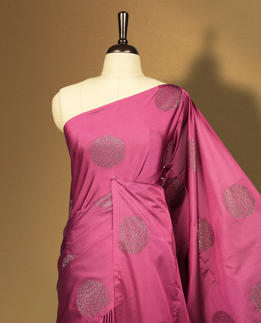 Soft Maroon colour semi soft silk saree adorned with woven circular motifs on the body, complemented by a rich contrast woven pallu with tassel detailing & Comes with a matching blouse piece.