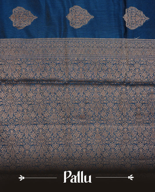 Teal Colour Pure Banaras Soft Silk saree featuring Antique Zari buttas in body, complemented by zari work on self colour border, paired with matching Blouse Piece.