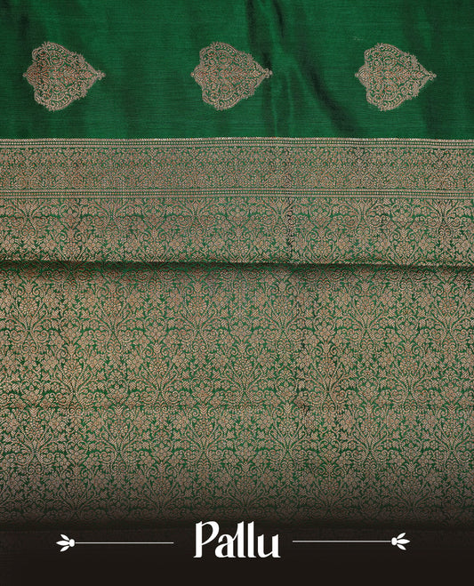 Green Colour Pure Banaras Soft Silk saree featuring Antique Zari buttas in body, complemented by zari work on self colour border, paired with matching Blouse Piece.