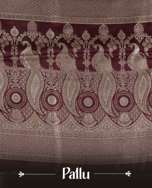 Maroon colour Mulberry silk saree featuring Gold zari buttas on body, complmented by self colour with Gold zari dual peacock in Temple design border, comes with matching blouse piece.