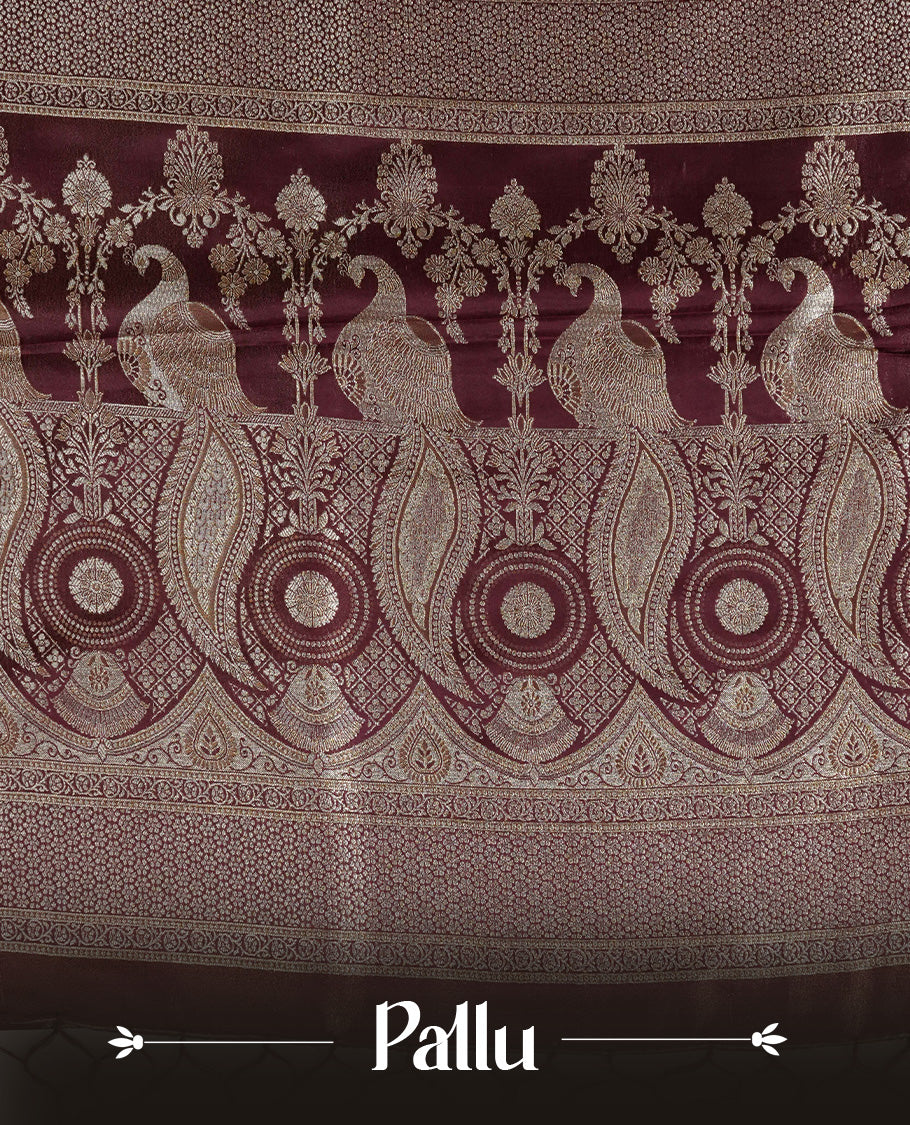 Maroon colour Mulberry silk saree featuring Gold zari buttas on body, complmented by self colour with Gold zari dual peacock in Temple design border, comes with matching blouse piece.