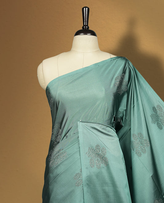 Turkish blue colour semi soft silk saree, beautifully designed with woven floral motifs & The look is enhanced by a rich contrast deep wine colour border and pallu with tassels, paired with a matching blouse.