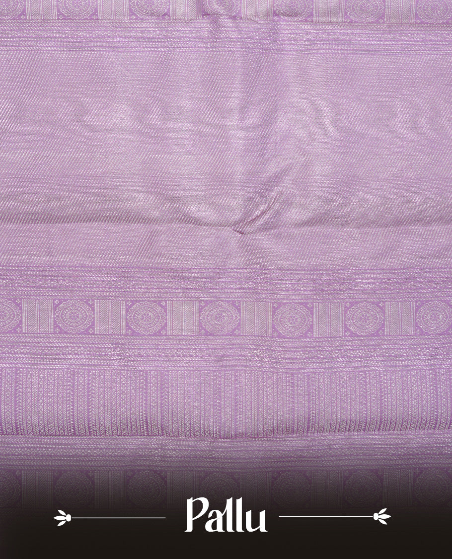 Lavender colour pure wedding silk saree featuring Silver zari Floral kodi pattern on body, complemented by self colour with traditional border, comes with matching blouse piece.