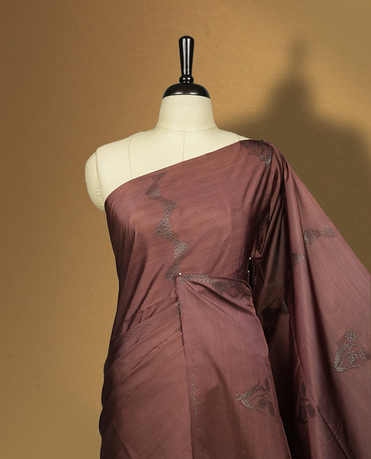 Brown colour semi soft silk saree with delicate woven motifs on the body, complemented by a beautifully designed pallu with tassels & Paired with a matching blouse piece, this drape exudes timeless elegance.
