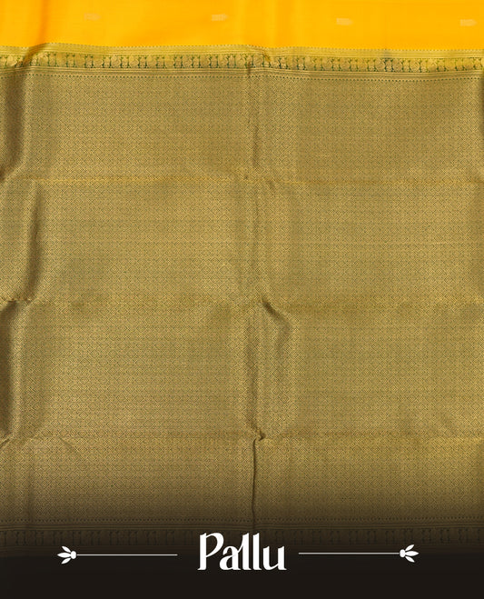Mustard Yellow colour Vasundhara silk saree adorned with all-over gold motifs on the body, complemented by a contrast dark green colour with gold mayil motifs border and paired with a matching blouse piece.