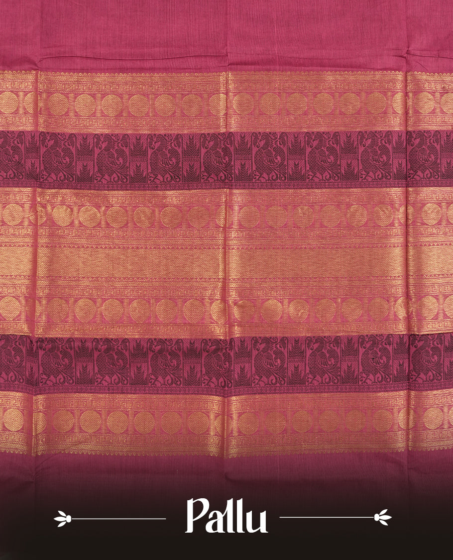 Magenta and Dark wine colour Chettinad cotton saree adorned with a single small woven motif on the body, highlighted by a golden zari border featuring circular patterns and intricate detailing & Paired with a matching blouse piece.