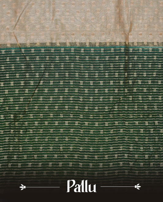 Cream colour Semi Tussar silk saree featuring an Gold zari motifs on body, accentuated by a contrast Dark green border adorned with intricate gold zari work, paired with a matching blouse piece.