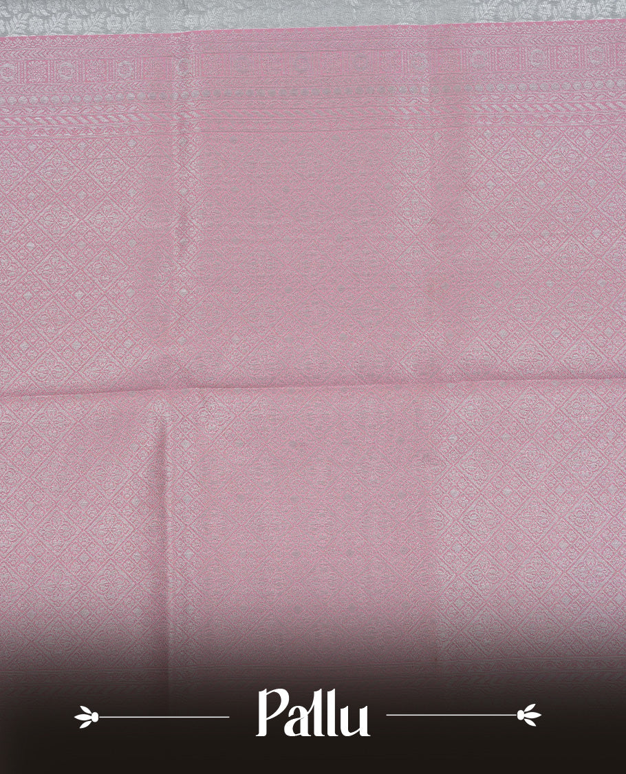Grey colour semi silk saree featuring Silver zari Floral pattern on body, complemented by contrast Peach colour with silver zari border, comes with matching blouse piece.