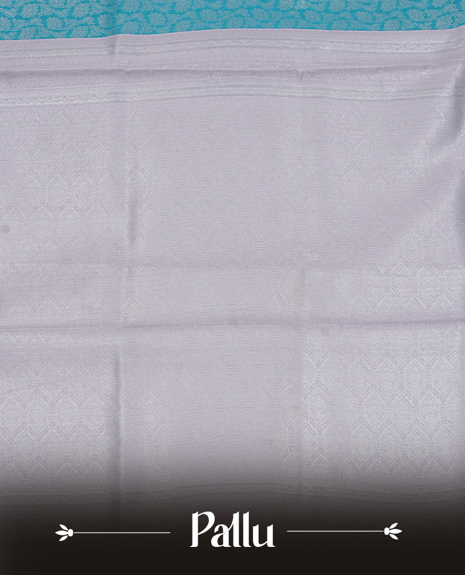 Aqua colour semi silk saree featuring Silver zari Floral pattern on body, complemented by contrast Lavender colour with silver zari border, comes with matching blouse piece.