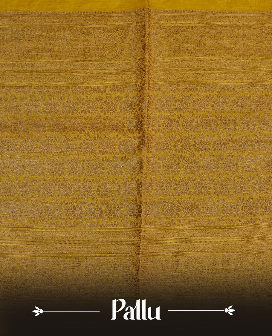Mustard colour semi linen saree with elegant gold zari Leaf motifs across the body, complemented by a contrast colour with grand gold zari pallu and a borderless design, paired with a matching blouse piece.
