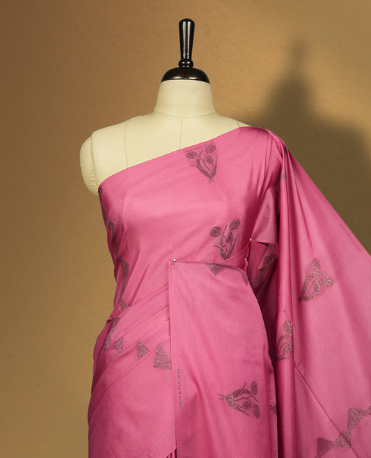 Soft pink colour semi soft silk saree, adorned with subtle woven floral motifs on the body & The design is elevated with an elegant zari border and pallu with tassels, paired with a matching blouse.