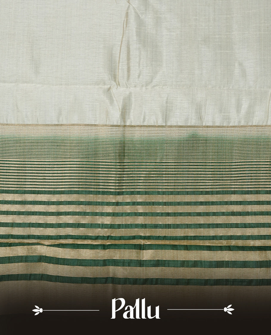 Light gold tussar saree featuring Elegant plain body, complemented by contrast dark green colour with Gold zari Floral kodi with Elephant Pattern border, comes with matching blouse piece.