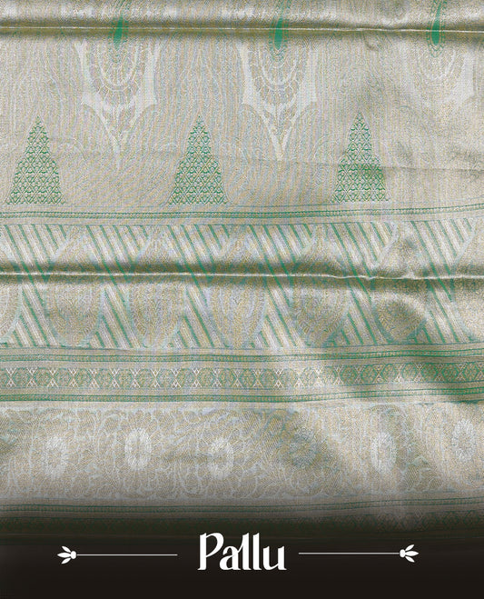 Light purple colour tissue saree featuring silver & gold zari floral kodi pattern on the body, highlighted by a contrast Green colour border with gold traditional zari, paired with a matching blouse piece.