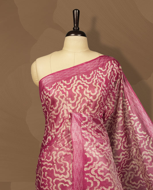 Pink colour semi jute tissue saree featuring delicate wave motifs on the body, complemented by a lustrous zari striped pallu and matching blouse piece for a refined festive look.
