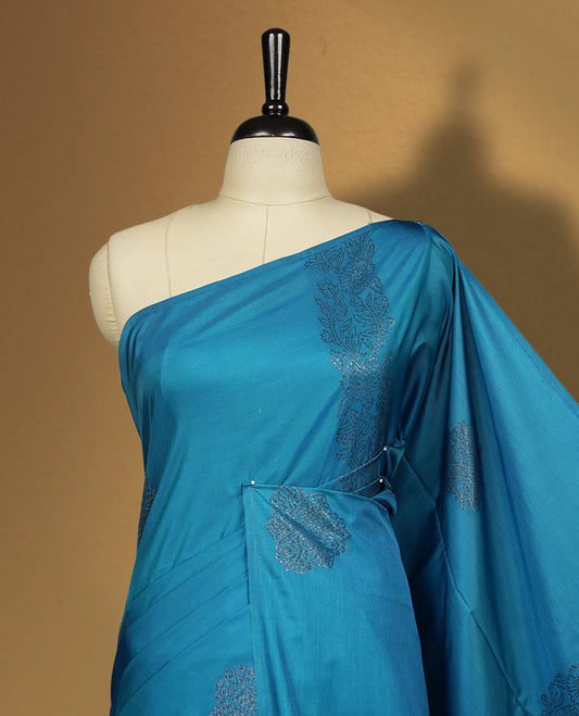 Rich Blue colour semi soft silk saree, adorned with subtle self woven motifs on the body & The design is elevated with an elegant zari border and pallu with tassels, paired with a matching blouse.