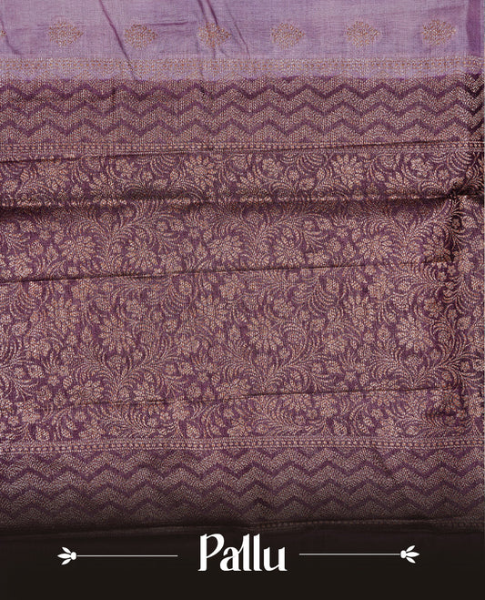 Pastel purple Colour Tussar silk saree featuring Antique Zari motifs on body, Finished with contrast Purple colour Zigzag zari pattern border, paired with matching blouse piece.
