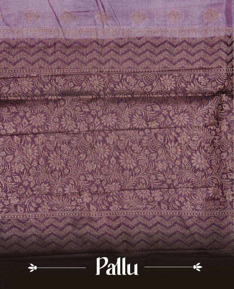 Pastel purple Colour Tussar silk saree featuring Antique Zari motifs on body, Finished with contrast Purple colour Zigzag zari pattern border, paired with matching blouse piece.