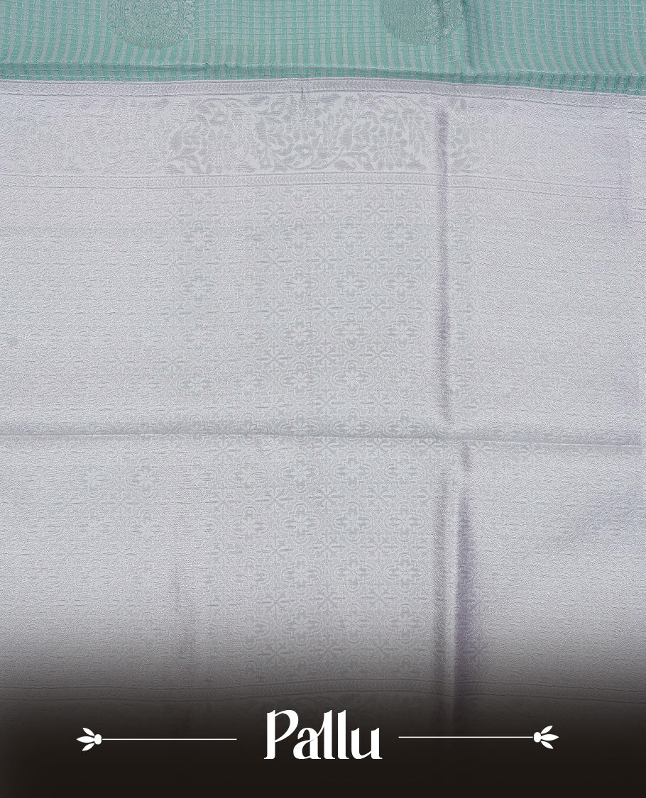 Aqua colour semi silk saree featuring Silver zari Small check pattern & motifs on body, complemented by contrast Lavender colour with silver zari border, comes with matching blouse piece.