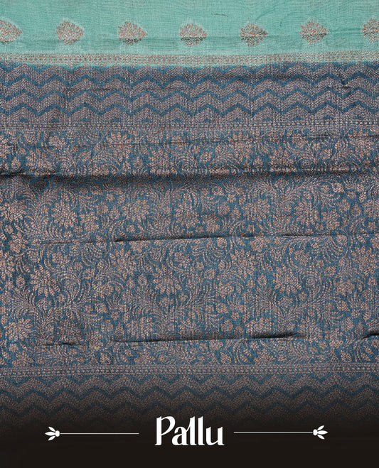 Aqua Colour Tussar silk saree featuring Antique Zari motifs on body, Finished with contrast Teal colour Zigzag zari pattern border, paired with matching blouse piece.