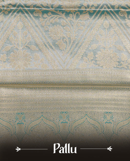 Light Pink colour Tissue silk saree featuring Gold zari Floral kodi design on body, enhance with Aqua colour with traditional zari border, paired with matching blouse piece.