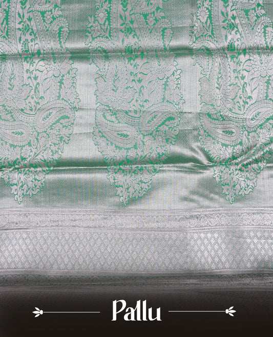Light green colour tissue saree featuring rose gold zari floral kodi pattern on the body, highlighted by a self colour border with rose gold traditional zari, paired with a matching blouse piece.